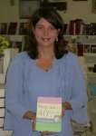 Tina M Ellis with her first book   Pregnancy  40 Weeks of Preparation 