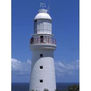 The 1848 Cape Otway Lighthouse Overlooks a Calm Sea Beneath a Blue Sky 
