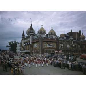 Marching Band and Spectators Fill Street Beside Corn Palace 
