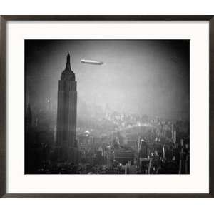 The Zeppelin Hindenburg Floats Past the Empire State Building Framed 