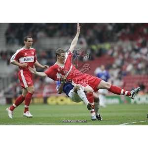    Middlesbroughs Robert Huth is pulled to ground by Framed Prints